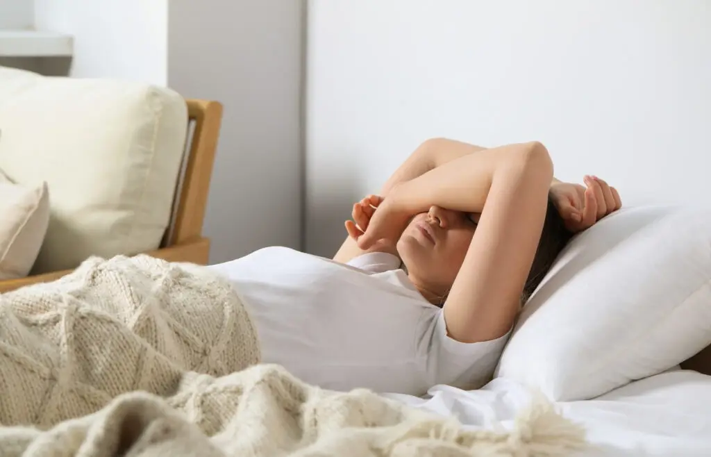 A woman tossing and turning not being able to sleep