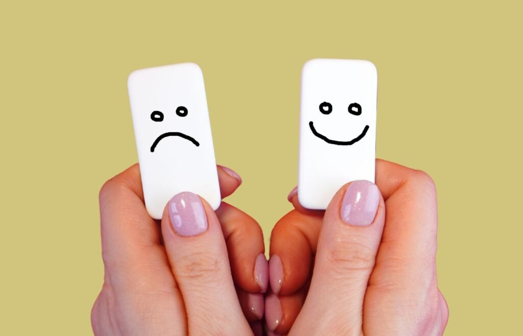 Two brackets, one with illustrated smiling face, the other with illustrated sad face