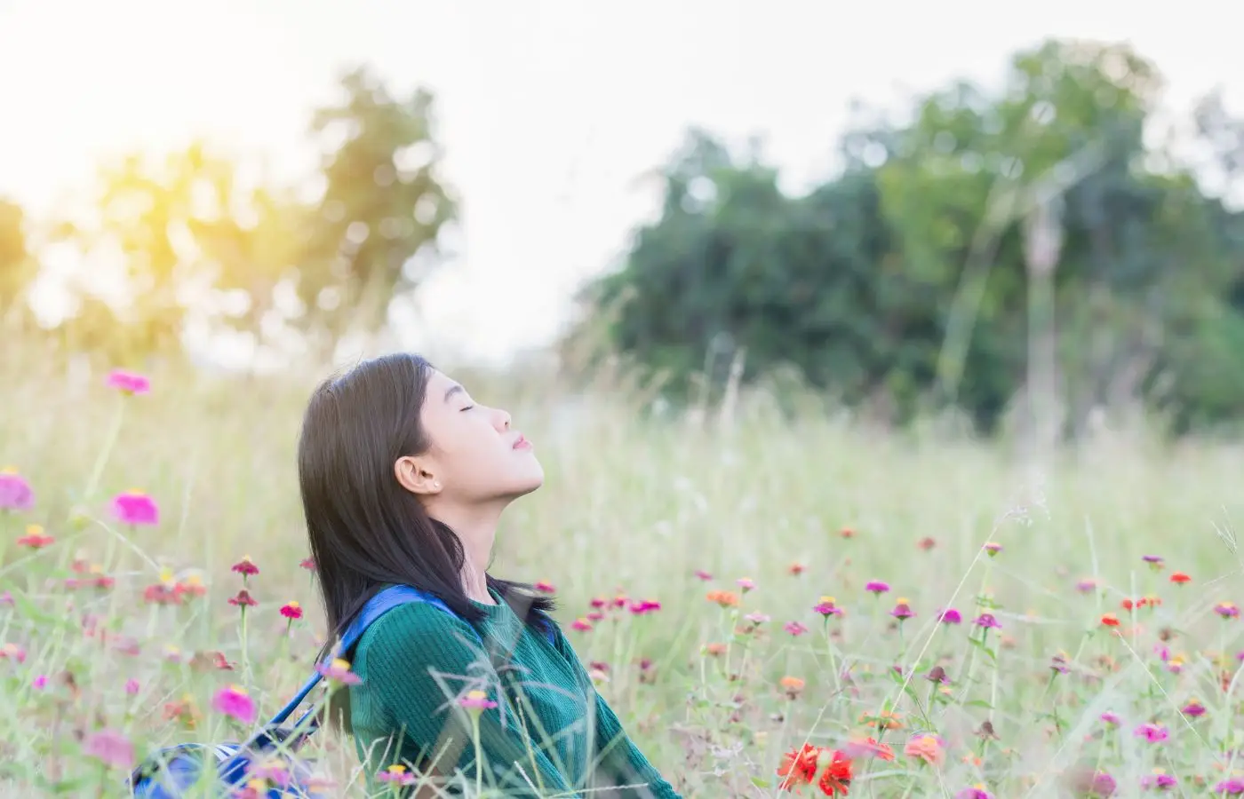 Woman doing conscious breathing in nature